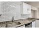 Kitchen with subway tile backsplash, stainless steel dishwasher and sink, and granite counter tops at 5119 Gateway Dr, Tampa, FL 33615
