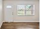 Bright living room featuring new flooring, fresh paint, and natural light from a large window at 5119 Gateway Dr, Tampa, FL 33615