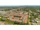 Wide aerial view of the community, showing the pool, pond, and surrounding neighborhood at 582 53Rd N Ave, St Petersburg, FL 33703