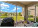 Screened back porch features a scenic view of the pond with a fountain and a seating area at 582 53Rd N Ave, St Petersburg, FL 33703