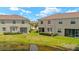 Rear exterior view of property with lush green backyard, pond view, and screened lanai at 582 53Rd N Ave, St Petersburg, FL 33703