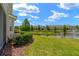 Lush backyard with a serene pond and fountain, complemented by well-maintained landscaping at 582 53Rd N Ave, St Petersburg, FL 33703