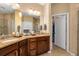 Well-lit bathroom with double sink vanity, granite countertop, and walk-in shower with a glass door and tile surround at 582 53Rd N Ave, St Petersburg, FL 33703