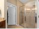 Bathroom featuring a glass-enclosed shower with tiled walls, a walk-in closet, and a tile floor at 582 53Rd N Ave, St Petersburg, FL 33703