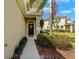 Charming front door with decorative wreath, framed by lush landscaping and mature palm tree at 582 53Rd N Ave, St Petersburg, FL 33703