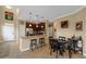 Eat-in kitchen boasts stainless appliances, granite countertops, dark wood cabinetry, and pendant lighting at 582 53Rd N Ave, St Petersburg, FL 33703