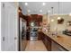 Well-appointed kitchen featuring stainless appliances, granite countertops, and dark wood cabinets at 582 53Rd N Ave, St Petersburg, FL 33703
