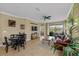 Spacious living room featuring a ceiling fan, tile floors, comfortable furniture, and serene pond view at 582 53Rd N Ave, St Petersburg, FL 33703