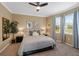 Comfortable bedroom featuring a ceiling fan, neutral walls, carpet and bright natural light from the large window at 582 53Rd N Ave, St Petersburg, FL 33703