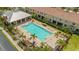 Aerial view of the community pool, featuring lounge chairs and shaded areas at 582 53Rd N Ave, St Petersburg, FL 33703