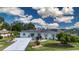 An aerial view of a nicely landscaped house highlighting the long driveway and manicured yard at 603 Fort Duquesna Dr, Sun City Center, FL 33573