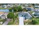 Scenic aerial of a beautifully landscaped home with manicured lawns and mature landscaping near a tranquil pond at 603 Fort Duquesna Dr, Sun City Center, FL 33573