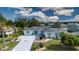 An aerial view of a beautifully landscaped house, showcasing its expansive driveway and well-maintained lawn at 603 Fort Duquesna Dr, Sun City Center, FL 33573