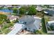 Scenic aerial view of a nicely landscaped house with manicured lawns, palm trees, and mature shrubs at 603 Fort Duquesna Dr, Sun City Center, FL 33573