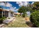 Spacious backyard featuring lush lawn, mature trees, and serene water view at 603 Fort Duquesna Dr, Sun City Center, FL 33573
