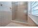 Enclosed glass shower with neutral tile and updated shower head and fixtures in this well maintained bathroom at 603 Fort Duquesna Dr, Sun City Center, FL 33573