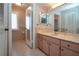 Bathroom features a long vanity with marble counter top and built in mirror with lighting at 603 Fort Duquesna Dr, Sun City Center, FL 33573