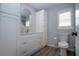 Updated bathroom with modern vanity, updated floors, and toilet near window and linen closet at 603 Fort Duquesna Dr, Sun City Center, FL 33573