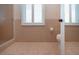 Bathroom features a toilet, window, tile floor, and shower/tub with sliding glass doors at 603 Fort Duquesna Dr, Sun City Center, FL 33573