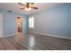 Bedroom features light blue walls, light wood flooring, one window, ceiling fan and bath access at 603 Fort Duquesna Dr, Sun City Center, FL 33573