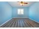 Bedroom featuring light blue walls, light wood flooring, one window and ceiling fan at 603 Fort Duquesna Dr, Sun City Center, FL 33573