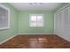 Bright bedroom with hardwood floors, a ceiling fan, large window and closet providing ample storage space at 603 Fort Duquesna Dr, Sun City Center, FL 33573