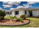 Well-maintained exterior with manicured garden and mature landscaping at 603 Fort Duquesna Dr, Sun City Center, FL 33573