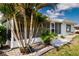 Exterior view of home with well-maintained lawn and lush tropical landscaping at 603 Fort Duquesna Dr, Sun City Center, FL 33573