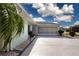 Charming exterior view showcasing the home's lovely landscaping, including a palm tree and well-kept lawn at 603 Fort Duquesna Dr, Sun City Center, FL 33573