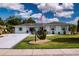 Charming home with a well-kept lawn, a pristine driveway, and mature trees at 603 Fort Duquesna Dr, Sun City Center, FL 33573