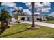 Inviting home with a well-maintained lawn, tropical landscaping, and a long, pristine driveway at 603 Fort Duquesna Dr, Sun City Center, FL 33573