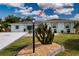 Charming single-story home featuring well-manicured landscaping and an American flag waving proudly at 603 Fort Duquesna Dr, Sun City Center, FL 33573