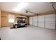 Epoxy-floored garage with golf cart parked next to a roll up door at 603 Fort Duquesna Dr, Sun City Center, FL 33573