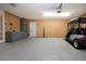 Large garage with epoxy floor, gray storage cabinets and a golf cart at 603 Fort Duquesna Dr, Sun City Center, FL 33573
