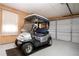 View of a clean and organized garage with a golf cart parked inside at 603 Fort Duquesna Dr, Sun City Center, FL 33573