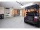 Clean garage featuring epoxy floor and gray wall cabinets, with a golf cart parked inside at 603 Fort Duquesna Dr, Sun City Center, FL 33573