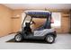 Garage with epoxy floor showcasing golf cart with blue and white canopy at 603 Fort Duquesna Dr, Sun City Center, FL 33573