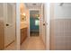 Hallway view with easy access to bedroom and bathroom offering neutral tile, lots of storage and a vanity at 603 Fort Duquesna Dr, Sun City Center, FL 33573