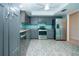 Kitchen with stainless steel appliances, gray cabinetry, light granite countertops and unique tile floors at 603 Fort Duquesna Dr, Sun City Center, FL 33573