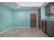 Kitchen area with mosaic flooring, blue walls, stainless dishwasher, cabinets and doorway access at 603 Fort Duquesna Dr, Sun City Center, FL 33573