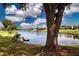 Serene lake view with a small dock and surrounding properties at 603 Fort Duquesna Dr, Sun City Center, FL 33573