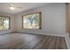 Bright living room featuring laminate floors, large windows with scenic backyard views and ceiling fan at 603 Fort Duquesna Dr, Sun City Center, FL 33573