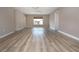 Open living room with ceiling fan, contemporary floors, and neutral paint with a view of the front yard at 603 Fort Duquesna Dr, Sun City Center, FL 33573
