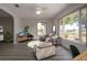 Staged living room area featuring laminate floors, large windows with backyard views and modern furniture at 603 Fort Duquesna Dr, Sun City Center, FL 33573