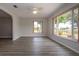 Open living room area featuring laminate floors, large windows with scenic backyard views and ceiling fan at 603 Fort Duquesna Dr, Sun City Center, FL 33573
