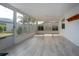 Bright sunroom with large windows offering garden views and neutral tile flooring at 603 Fort Duquesna Dr, Sun City Center, FL 33573