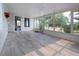 Spacious sunroom with tile floors, large windows, and access to the outdoors at 603 Fort Duquesna Dr, Sun City Center, FL 33573