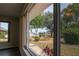 Beautiful window view of backyard landscaping, pond, and windmill at 603 Fort Duquesna Dr, Sun City Center, FL 33573