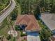 An aerial view of a single-story home featuring a well-manicured lawn and mature landscaping at 617 Glastonbury Ct, Spring Hill, FL 34609