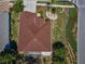 A bird's eye view of a single-story home highlighting the roof and surrounding landscaping at 617 Glastonbury Ct, Spring Hill, FL 34609